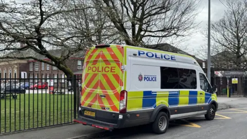 Police van parked outside the school gates