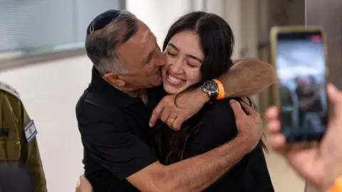 Reuters Noa Argamani embraces her father Yakov Argamani