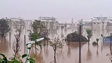 A river in Qingyuan city burst its banks and flooded an adjacent pier and roads
