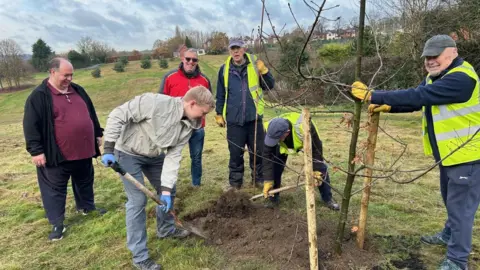 Erewash Borough Council Volunteers and councillors mucking in to plant a young tree