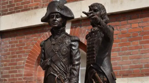 Bronze statue of Lord Nelson (left) and Sir George Murray pointing outside Murray's former home in North Street in Chichester