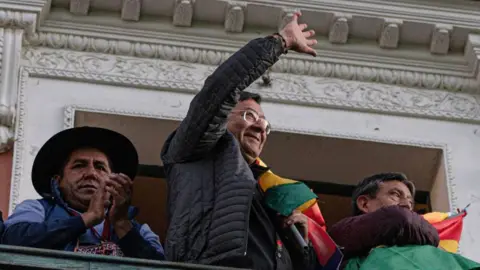 Getty Images President Luis Arce waves to protesters, June 26, 2024