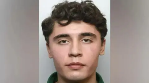 METROPOLITAN POLICE Daniel Khalife, wearing a green polo shirt, with cropped curly brown hair, looks on in a police photograph