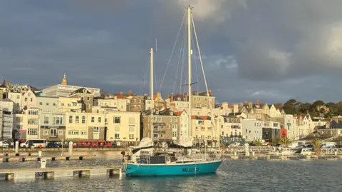 Guernsey Ports A blue yacht in St Peter Port harbour