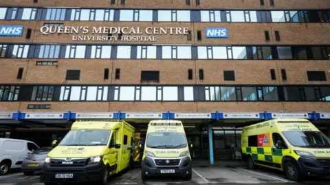 PA Media The Queen's Medical Centre front view with ambulances in front of it
