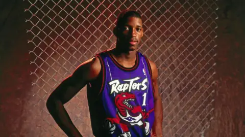 Getty Images Tracy McGrady #1 of the Toronto Raptors poses for a portrait during the 1997 NBA Rookie Photo Shoot on September of 1997 at the YMCA of Leesburg in Leesburg, Virginia. 