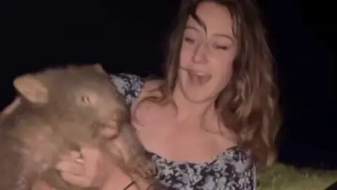 The woman holding the wombat