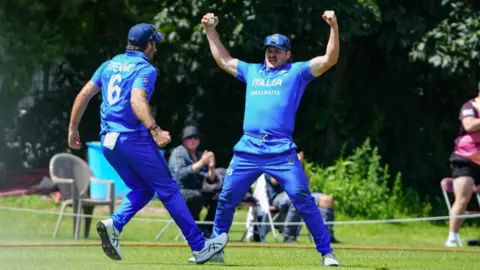 Italian players celebrate a wicket