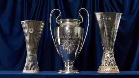 A group photo of the trophies for the Uefa Conference League, Uefa Champions League and Uefa Europa League
