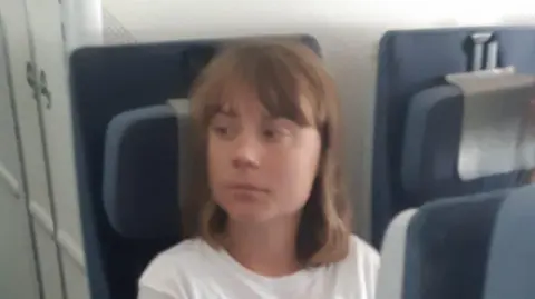 Israeli foreign ministry handout photo showing Swedish campaigner Greta Thunberg on board a plane from Israel to France (10 June 2025)