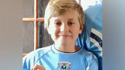 Family Keaton smiling in a Coventry City shirt