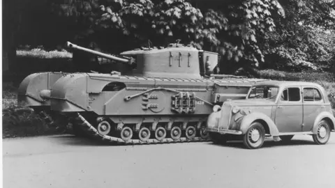 Vauxhall Heritage A World War Two tank beside a pre-war car with a tree in the background