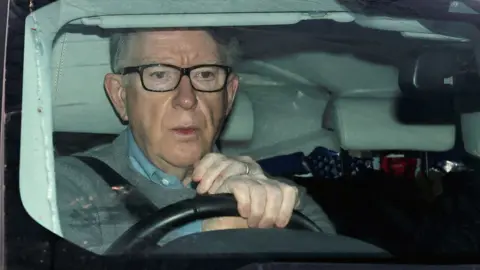 Reuters Former British ambassador to the US Peter Mandelson sits in a vehicle in London on 11 March 2026.