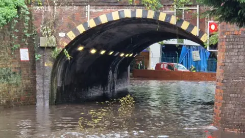 Flood water under a railway bridge