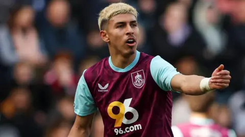 Jeremy Sarmiento playing for Burnley last season, making a gesture to another player with his left arm outstretched