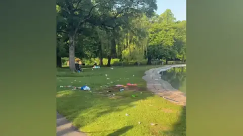 Sohail Khan Litter can be seen left on the grass by the pool in Tettenhall. The sun is shining and it looks serene but packaging and bags can be seen dotted about around and under trees.
