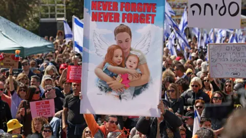 Getty Images crowd carrying Bibas and two children