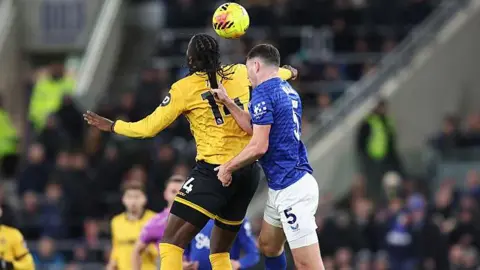 Everton's Michael Keane pulls the hair of Wolves' Tolu Arokodare