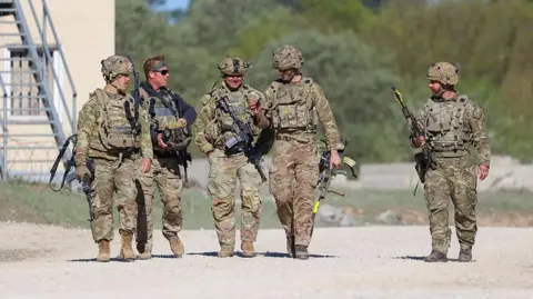US troops walking with guns during a training exercise in Germany