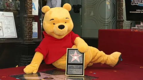 Getty Images A person dressed in costume as Winnie-the-Pooh, pictured receiving a star on the Walk of Fame in Los Angeles