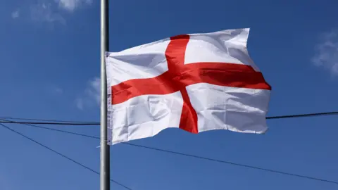REUTERS/Jack Taylor A St George's Cross flag attached to a lamppost.