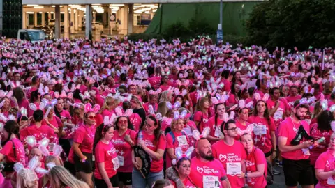 People in pink lined up at the start of the Sparkle Night Walk