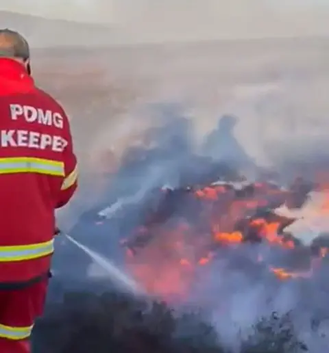 Peak District Moorland Group Peak District Moorland Group gamekeeper tackling a wildfire off Snake Pass in the Peak District, near Glossop, Derbyshire, on Friday 1 May 2026.