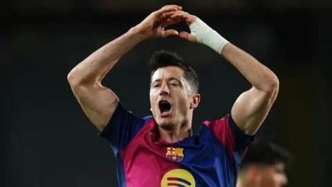 Robert Lewandowski celebrates scoring for Barcelona against Brest