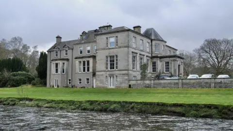 Kingsmeadows House, a stately-looking home, sitting on the banks of the river Tweed, surrounded by woodland