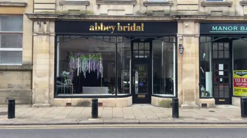 BBC/NATHAN TURVEY A picture of the Abbey Bridal shop in Pontefract, it's closed and in darkness and there are no wedding dresses visible.