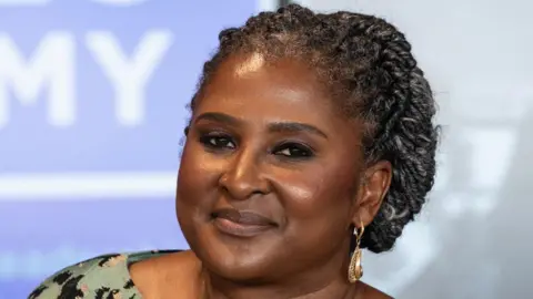 Getty Images The former first lady of Namibia is seen with a smile on her face in a head shot taken at an event.