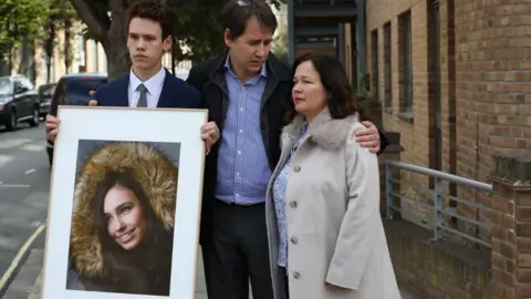 PA Media Nadim and Tanya Ednan-Laperouse, with their son Alex, outside West London Coroners Court in 2018 following the conclusion of the inquest into the death of Natasha Ednan-Laperouse