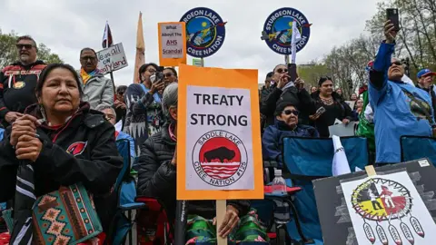 Getty Images An image showing dozens of First Nations members gathered outside the Alberta legislature in Edmonton, holding signs that say TREATY STRONG and WE ARE ALL ON TREATY LAND