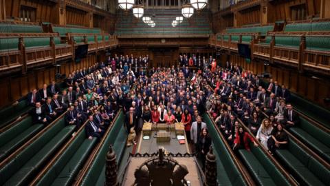 Members of Parliament, newly elected in the 2024 general election, gather in the House of Commons Chamber for a group photo