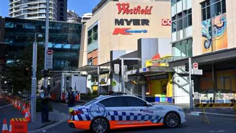 EPA A police car parked outside the Westfield Bondi Junction shopping centre