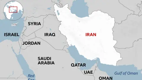 A regional map highlighting Iran in white with its name in red. Surrounding countries are labeled in grey, neighbouring Iraq to the west and other Middle Eastern countries including Syria, Jordan, Israel, Gaza and Saudi Arabia, Qatar, UAE, and Oman. Bodies of water such as the Red Sea and the Gulf of Oman are marked in blue