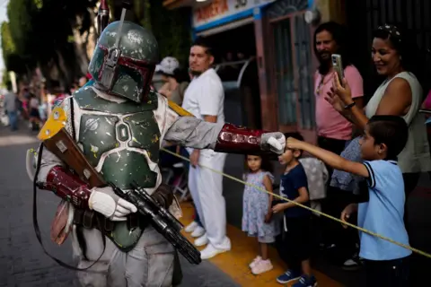 Rodrigo Oropeza / AFP A Star Wars fan dressed as Boba Fett takes part in the parade