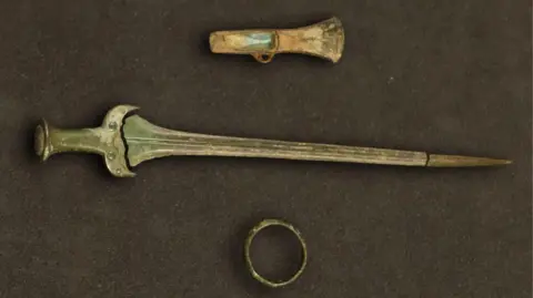 Middle Bronze Age rapier, a bangle and palstave axe head. 