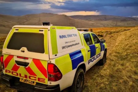 Derbyshire Police A police van in a moorland in Derbyshire.