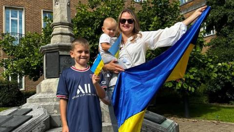 family holding Ukrainian flag