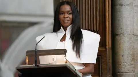 PA Media Oti Mabuse addresses the service at Westminster Abbey