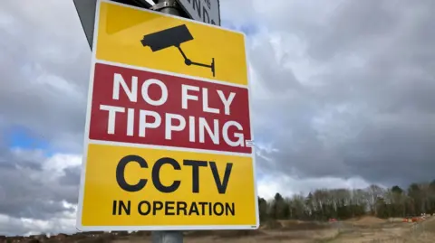 Andy Trigg/BBC A sign that says "no fly tipping CCTV in operation"