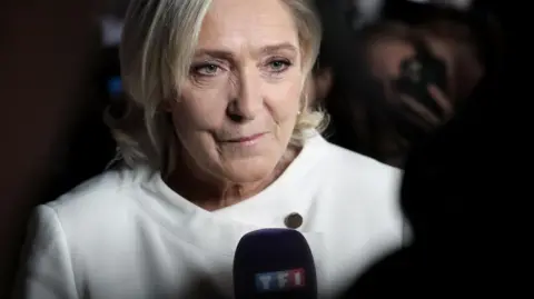 EPA Marine Le Pen addresses journalists after the second round of voting.