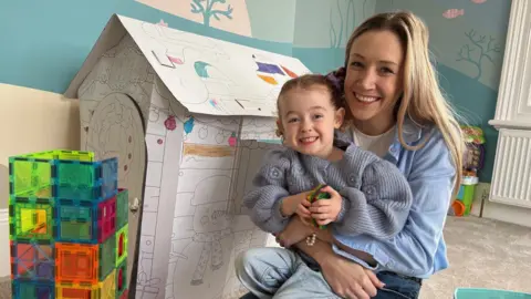 Mum with child and toys.