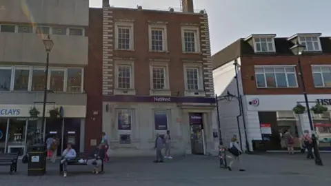 The image shows a closed down NatWest on Staines High Street.
