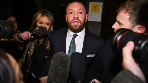 Getty Images Conor McGregor meninggalkan pengadilan