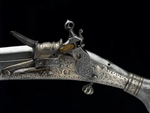 National Museums Scotland / PA A detail of a Jacobite pistol, decorated with floral engravings