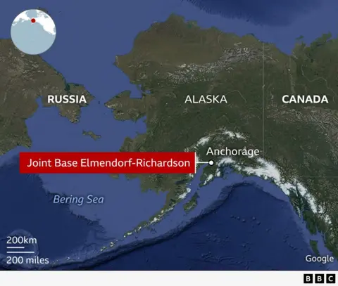 Map showing Alaska, Canada, and Russia with the Bering Sea in between. Anchorage is marked in southern Alaska. The map highlights how Alaska and Russia are geographically close, separated by only a narrow stretch of water. An inset globe in the top left shows the region’s location in the northern Pacific. It also shows where Joint Base Elmendorf Richardson is.