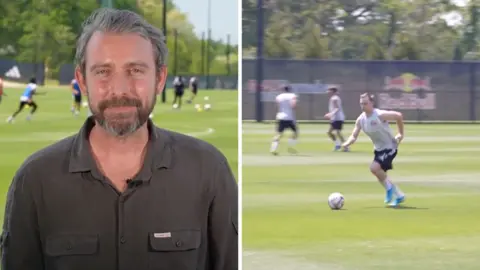 On the left, a man in a dark green shirt. On the right, a man in white shirt plays soccer.