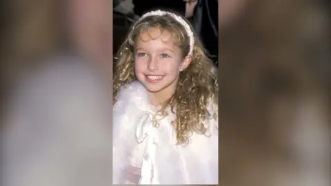 Archive image of Hayden smiling, as a young child, at Bug's Life premiere